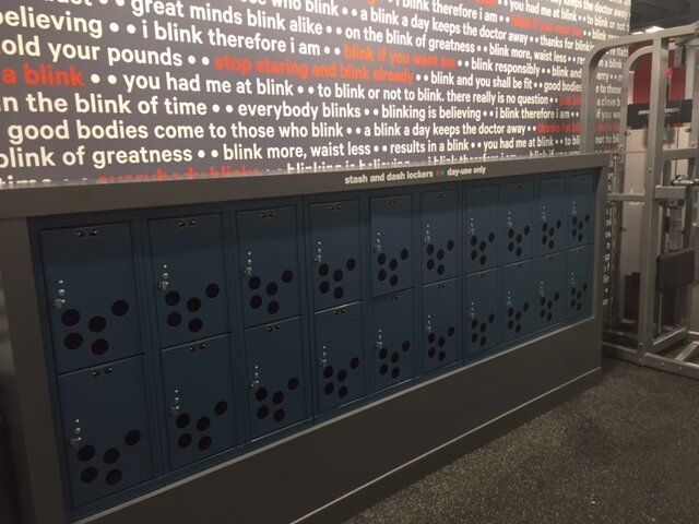A gym with lockers and a wall that says great minds blink therefore i am old your pounds