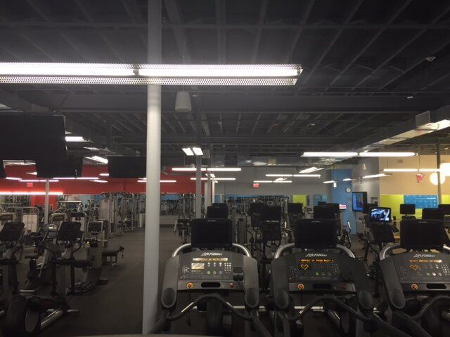 A gym with a lot of treadmills in it