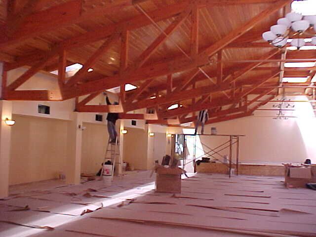 A large room with wooden beams and a chandelier