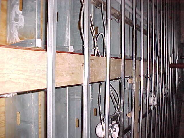 A wall with a lot of wires coming out of it