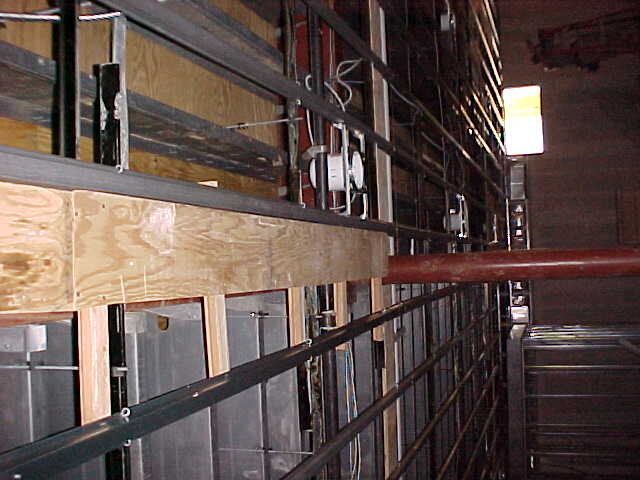 A building under construction with a pipe hanging from the ceiling