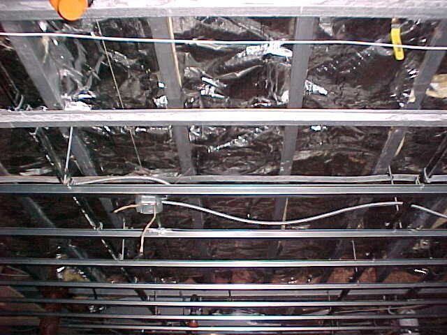 A ceiling with a lot of wires hanging from it