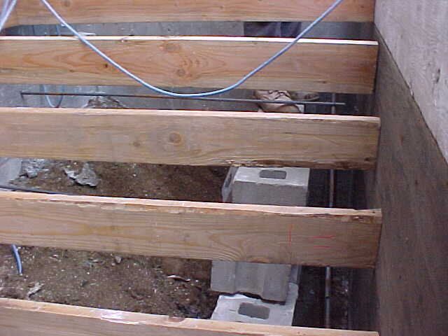 A wooden floor with a few wires hanging from it
