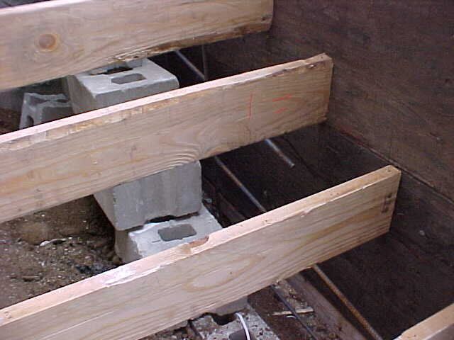 A row of wooden beams sitting on top of concrete blocks