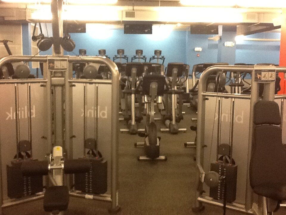 A row of exercise bikes in a gym with the word pink on them