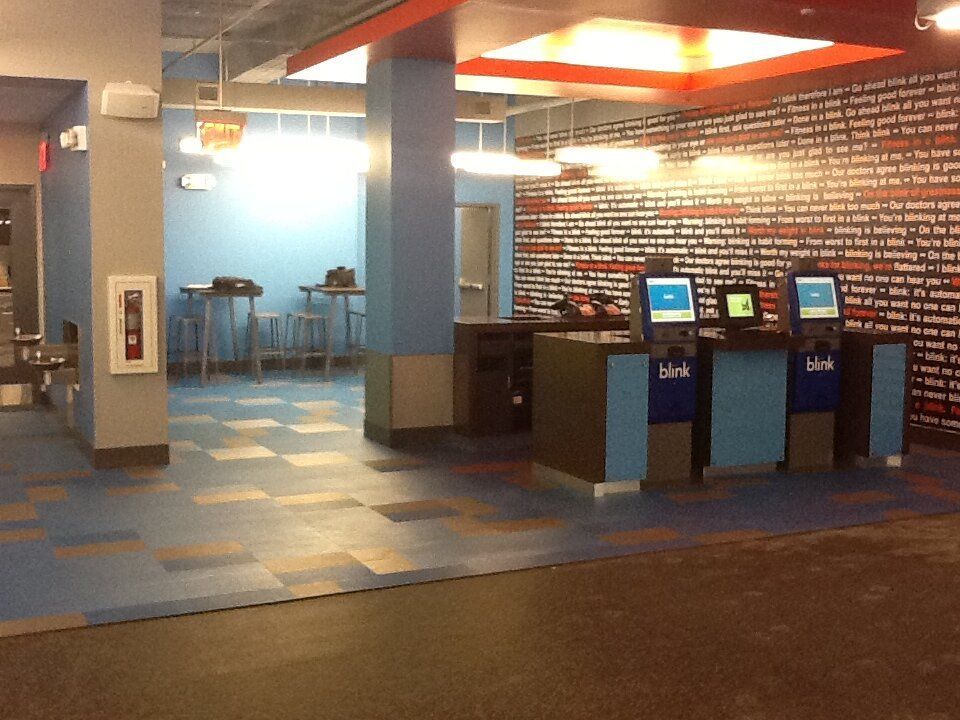 A room with a brick wall and a few kiosks that say ' link ' on them