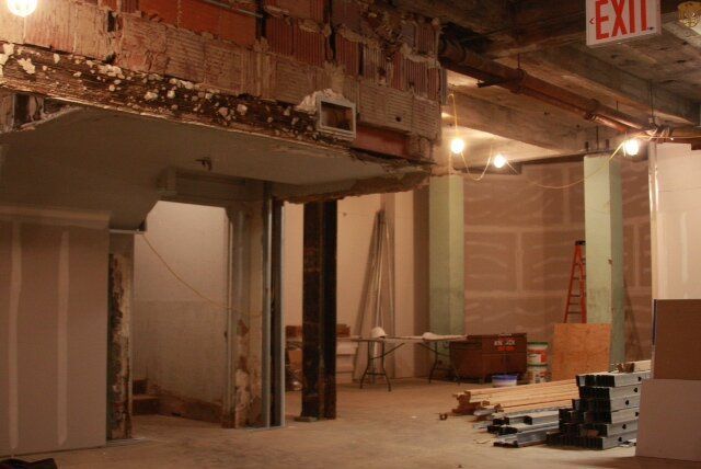 An empty room with a red exit sign above it