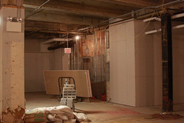 An empty room with a sign that says exit on it.