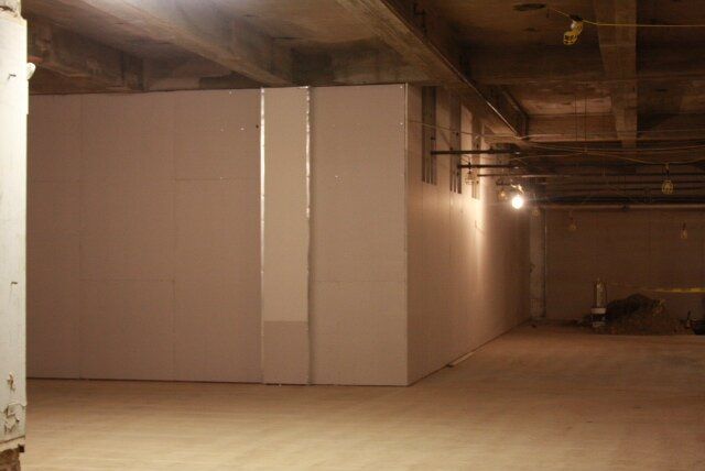 An empty room with white walls and a light on the ceiling