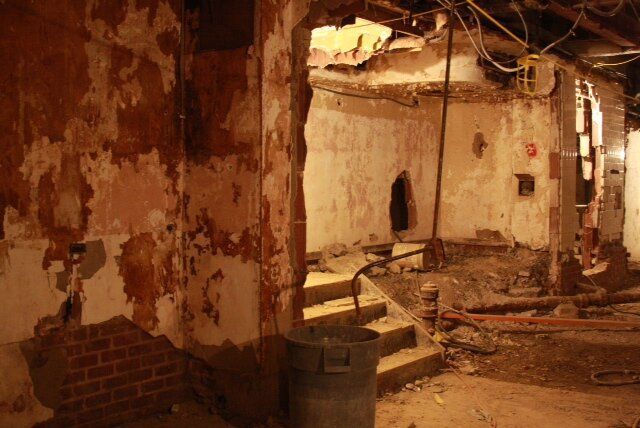 There is a trash can in the middle of the room.