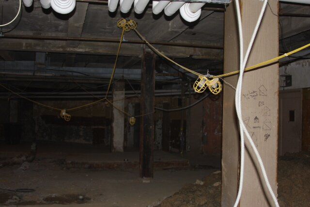 A room with a lot of wires hanging from the ceiling