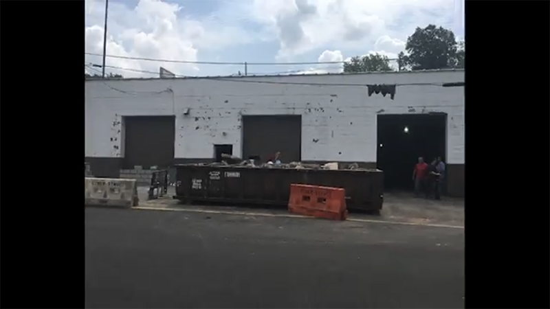 A group of people are standing outside of a building.