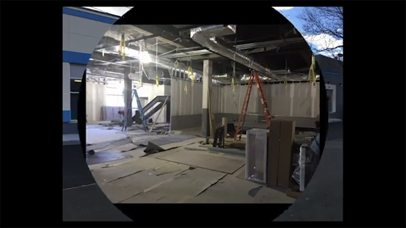 A picture of a building under construction with a ladder hanging from the ceiling.