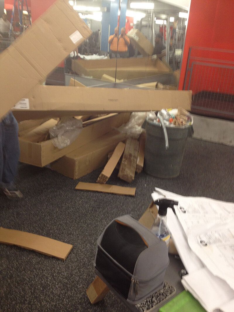 A pile of cardboard boxes sits on the floor in a room