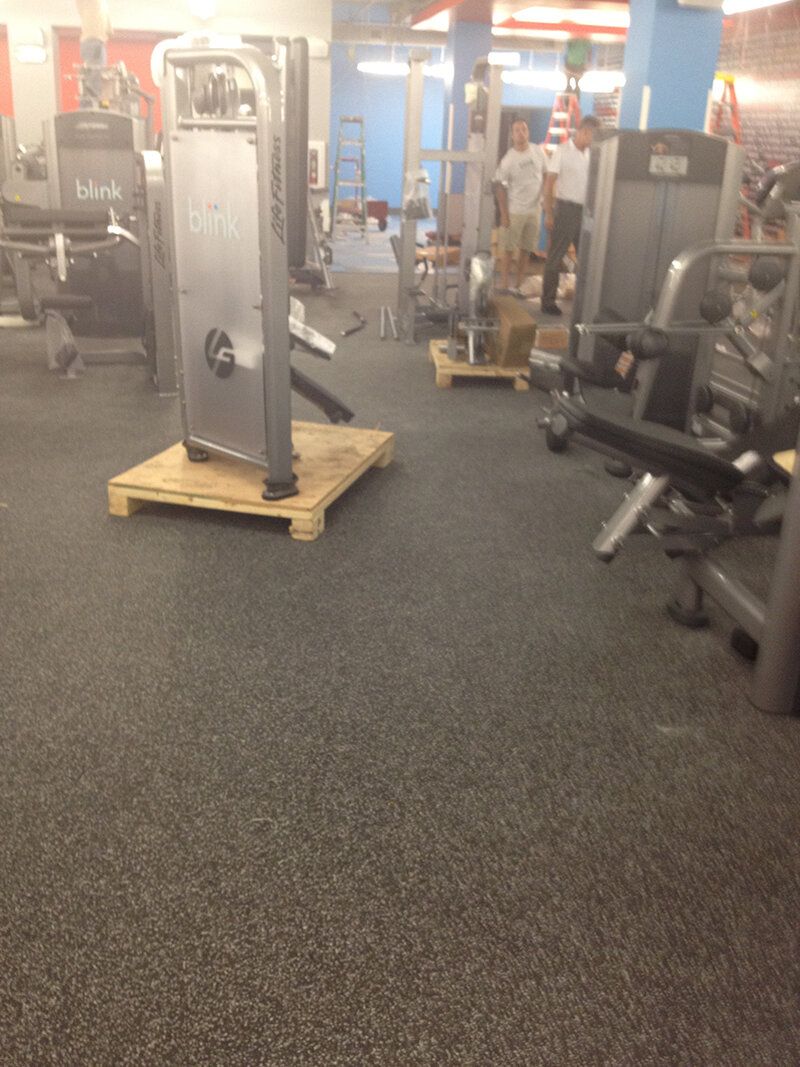 A gym with a wooden pallet in the middle of it