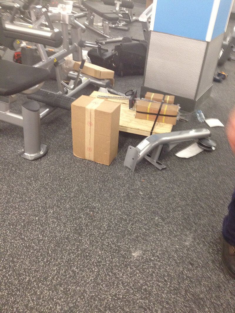 A box is sitting on the floor in a gym