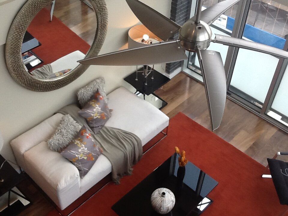 An aerial view of a living room with a ceiling fan