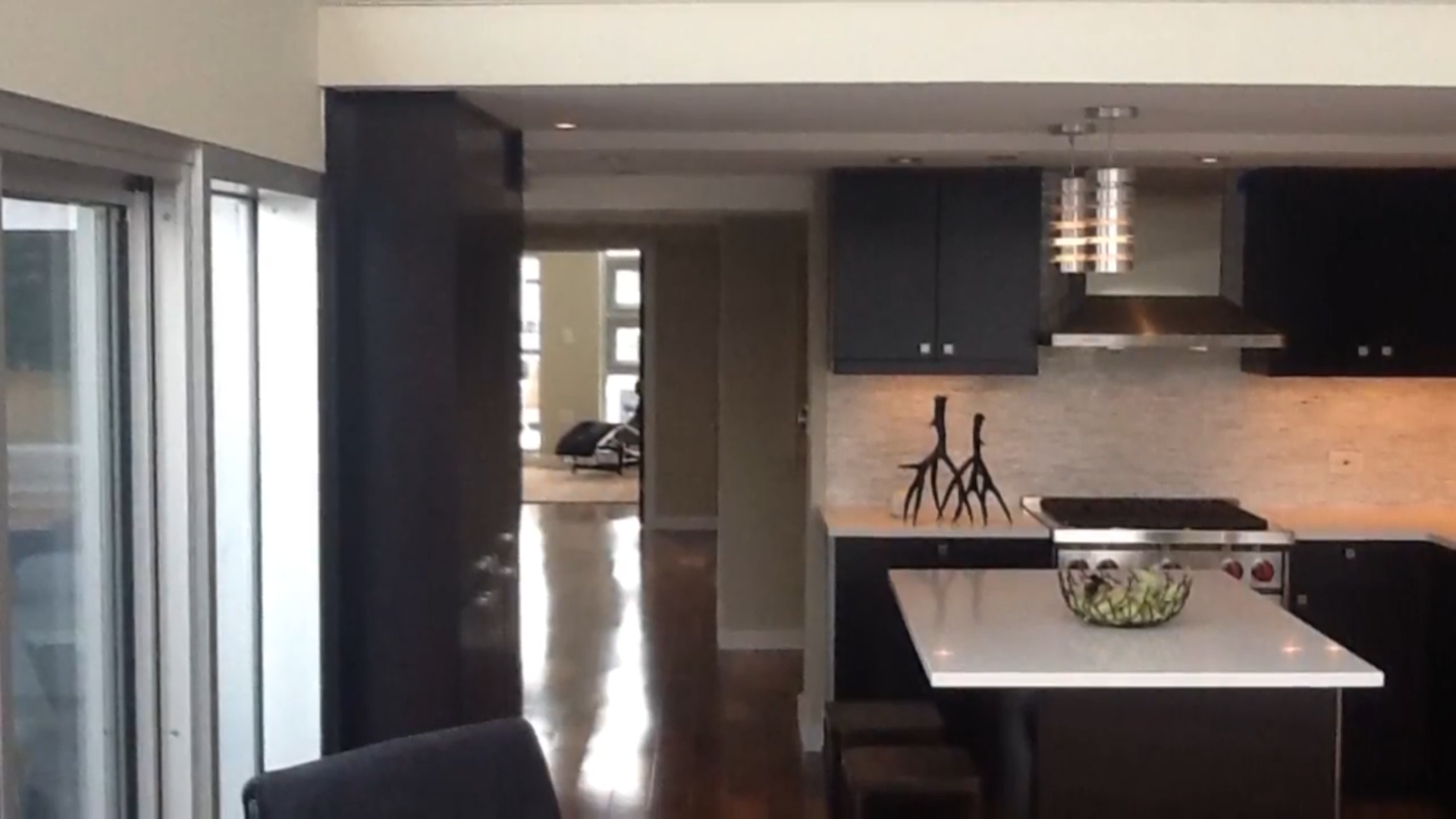 A kitchen with black cabinets and a white counter top