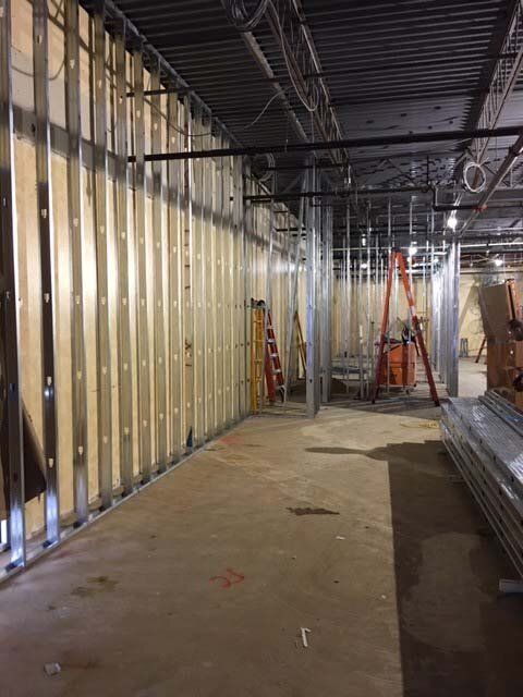 A large room with a lot of metal walls and a ladder.