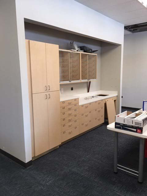 A kitchen with wooden cabinets and a table
