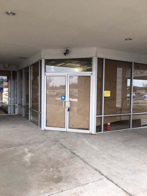 A building with a lot of windows and a door that is empty.