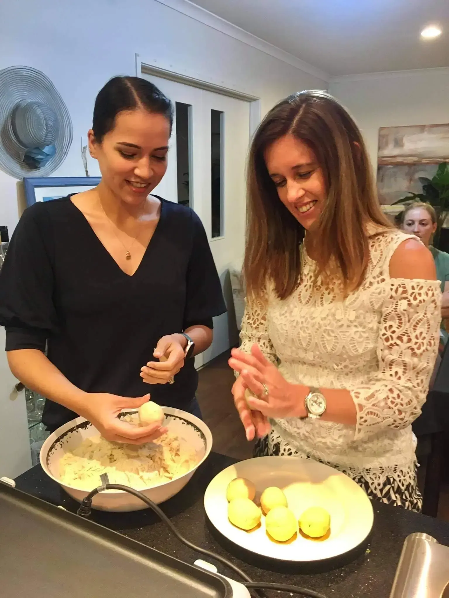 Kate Preece and a lady are standing next to each other in a kitchen preparing food.