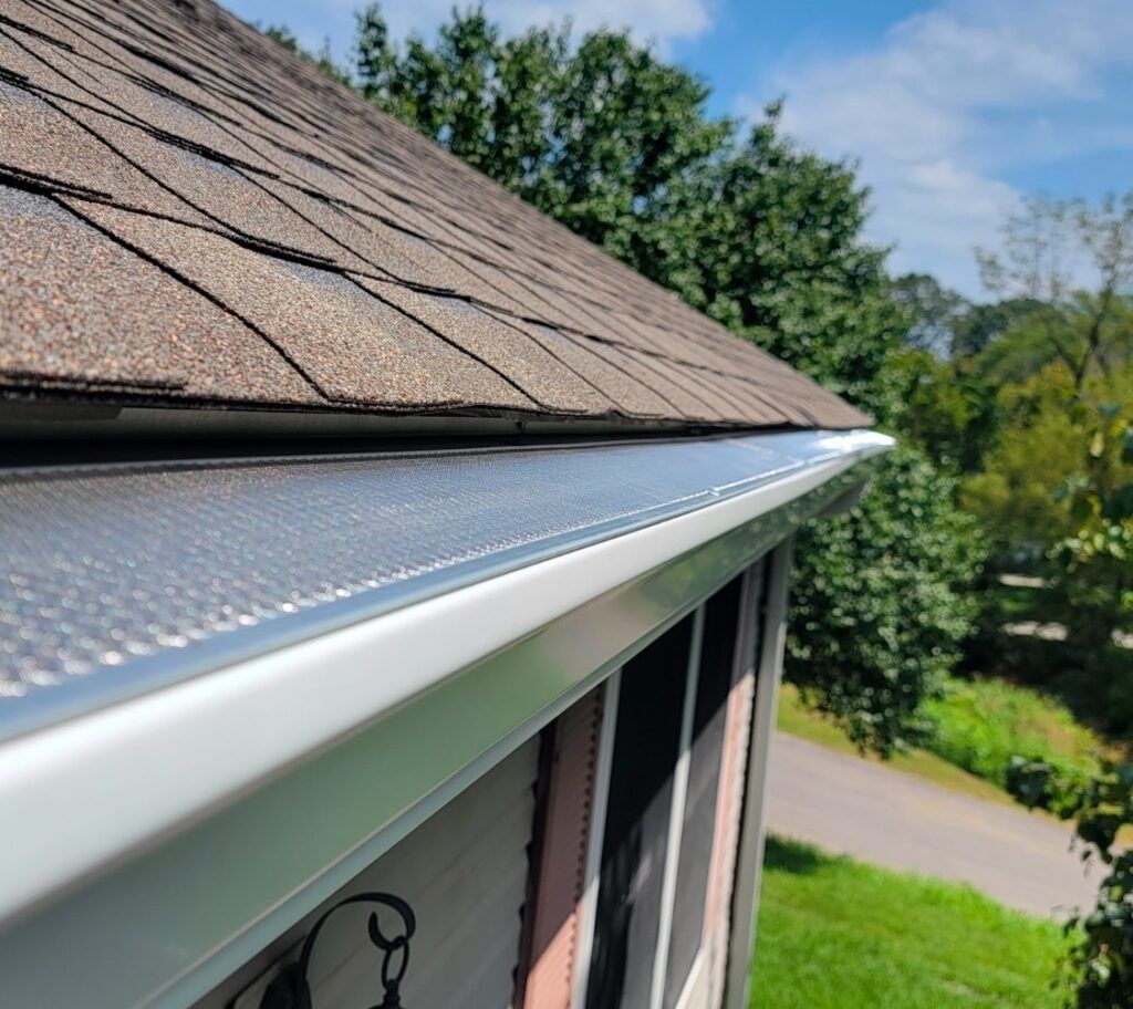 Gray metal roof with matching gutters and downspout, exterior view.