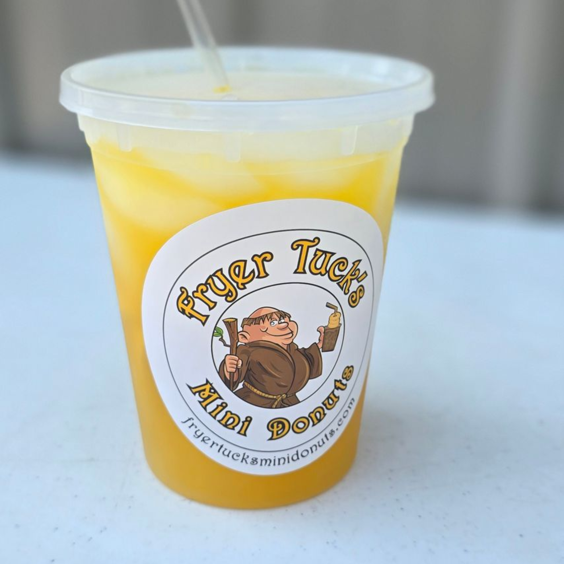 Assorted chocolate donuts with various toppings: marshmallows, sprinkles, and nuts, on a wire rack.