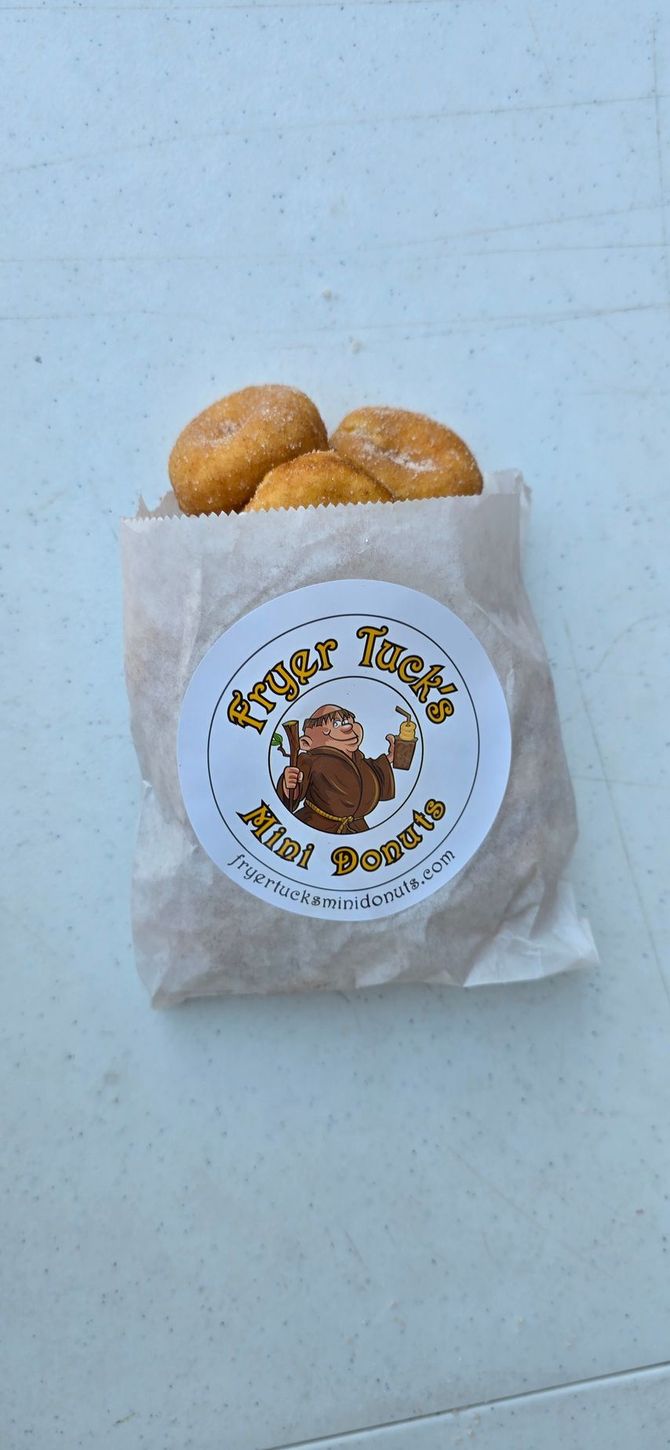 Close-up of a variety of colorful donuts, with icing, sprinkles, and glaze.