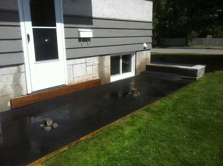 A house with a black patio in front of it