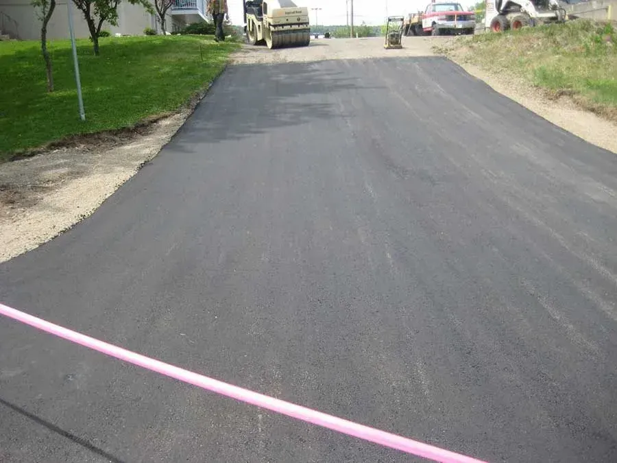 A road with a pink line on the side of it