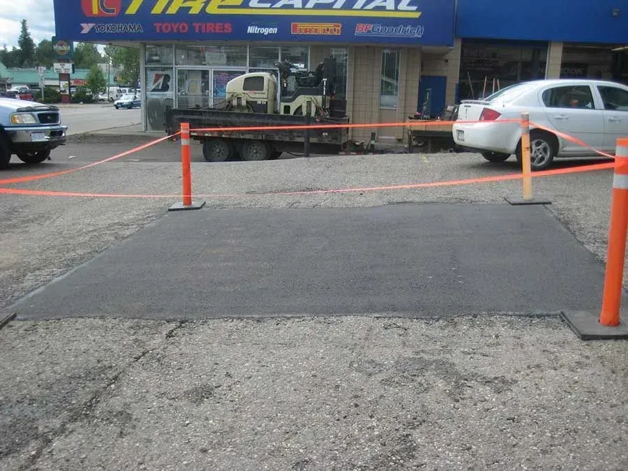 A car is parked in front of a tire capital store