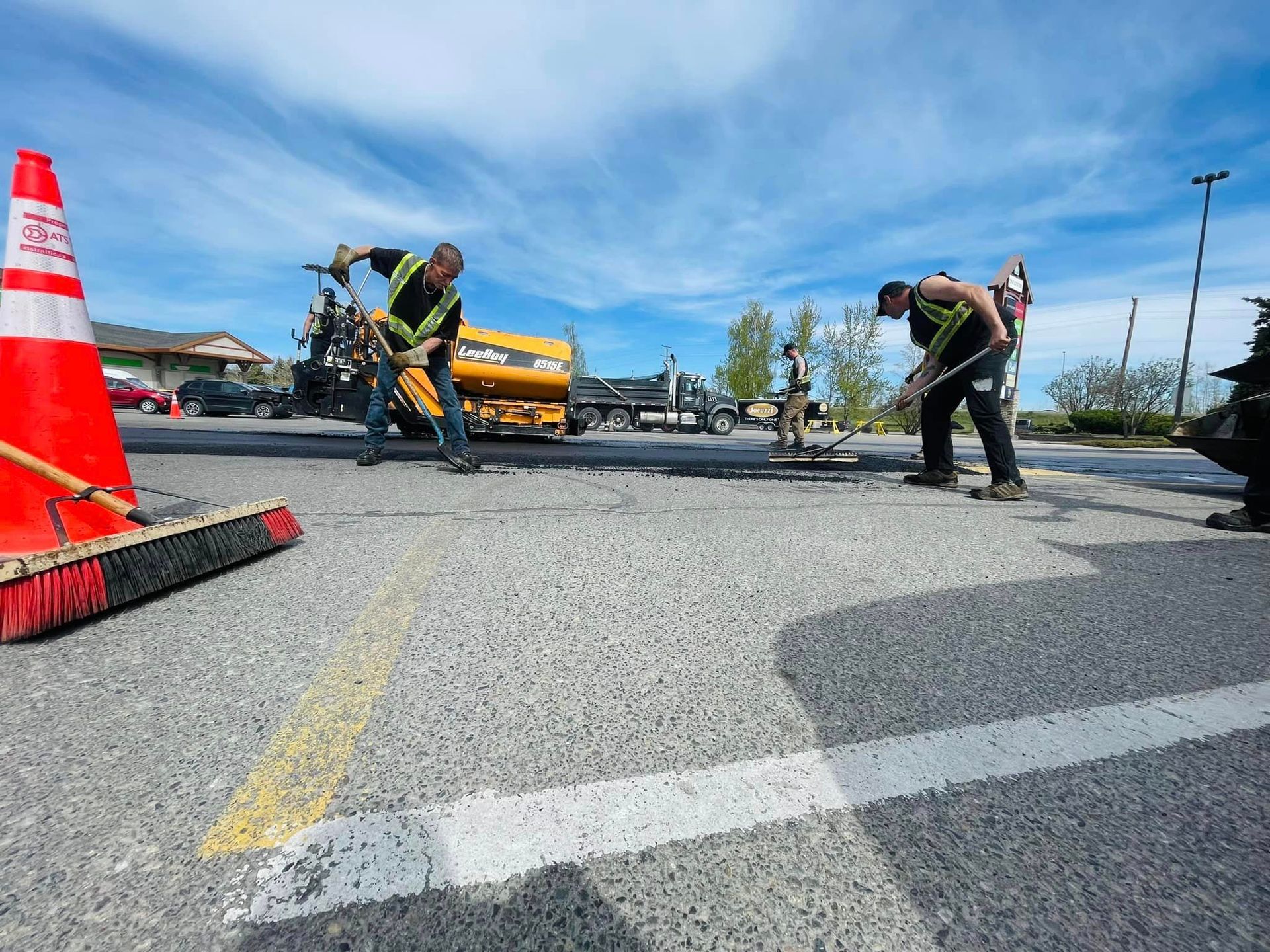 A group of construction workers are working on a road.