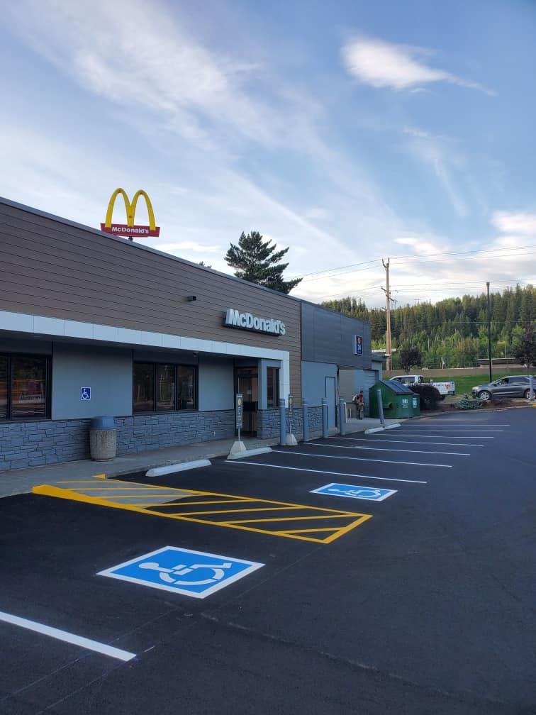 A mcdonald 's restaurant with a handicapped parking spot in front of it