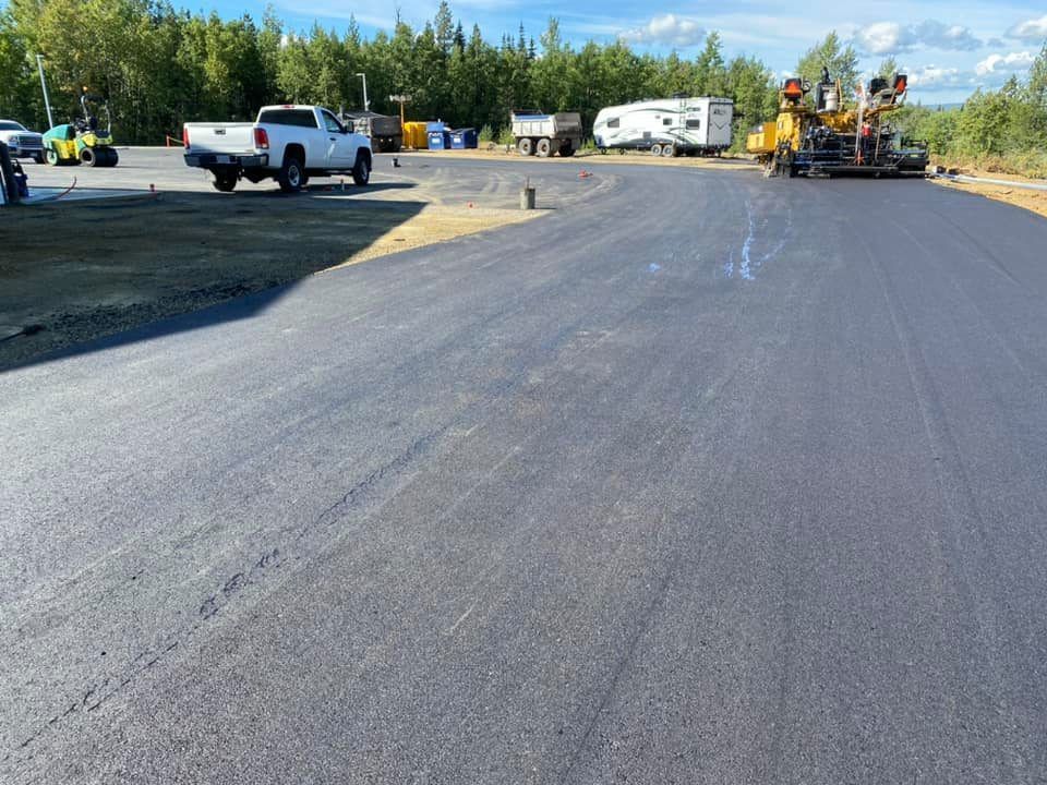 A white truck is parked on the side of a road.