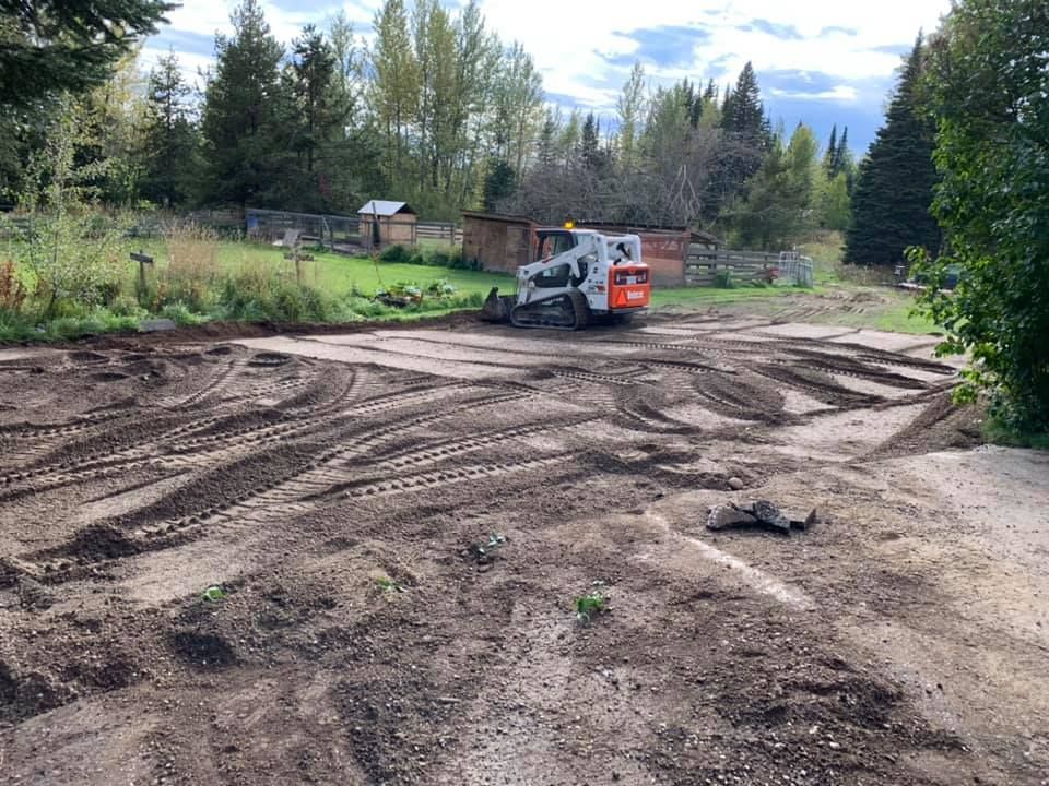 A bulldozer is moving dirt in a dirt field.