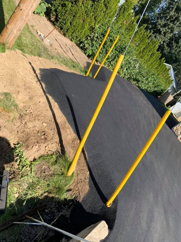 A yellow pole is sticking out of a hole in the ground.