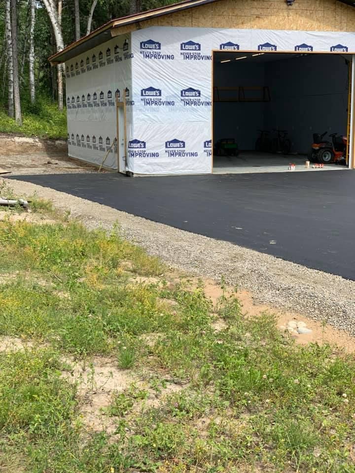 A garage is being built in the middle of a grassy field.