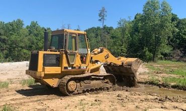 Backhoe Digging Soil — Foristell, MO — Wildschuetz Bros.  Trucking Inc