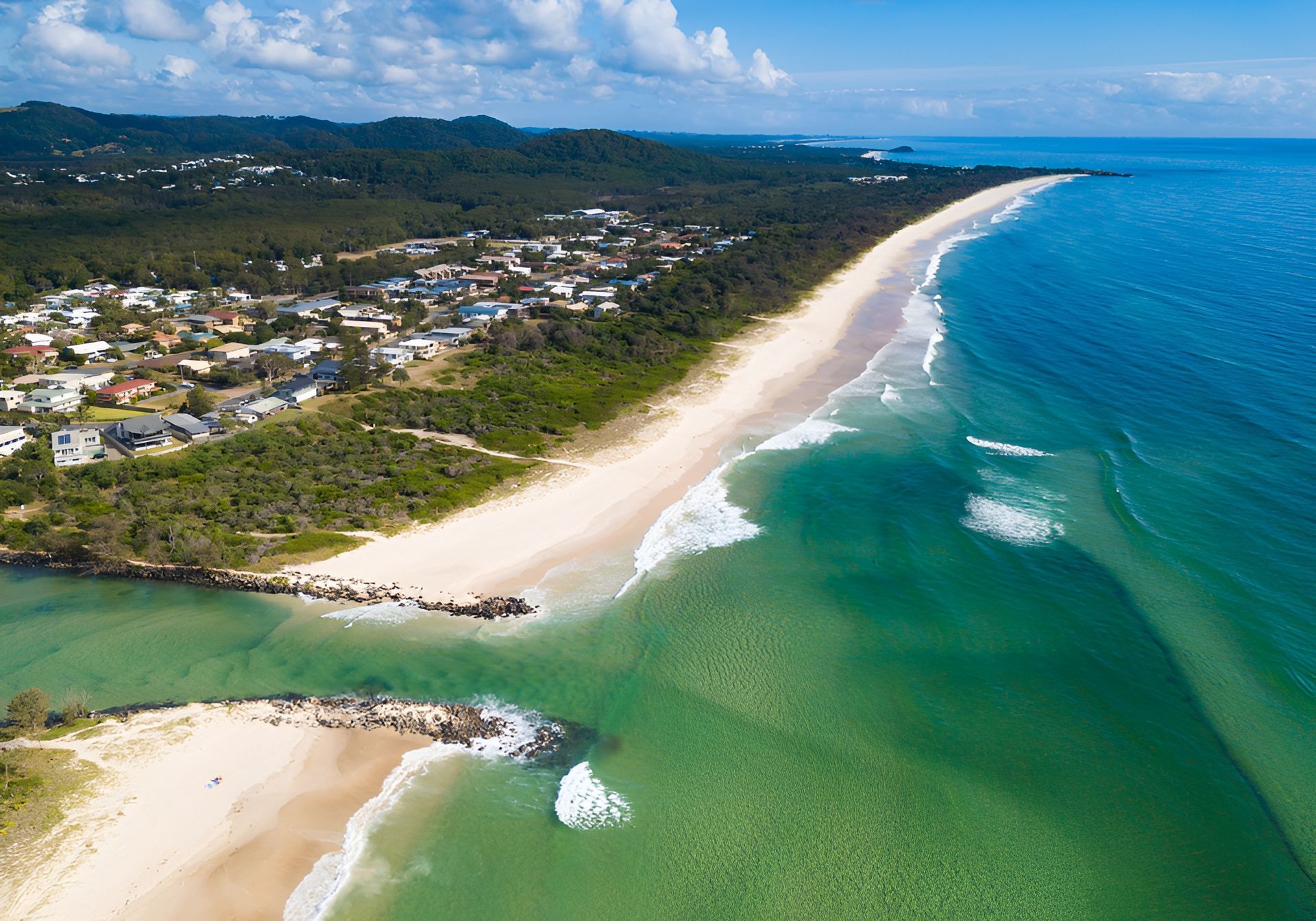 Aerial View of A Beach Where Green-Blue Ocean Water Meets the Sand — Dan's Removals In Pottsville, NSW
