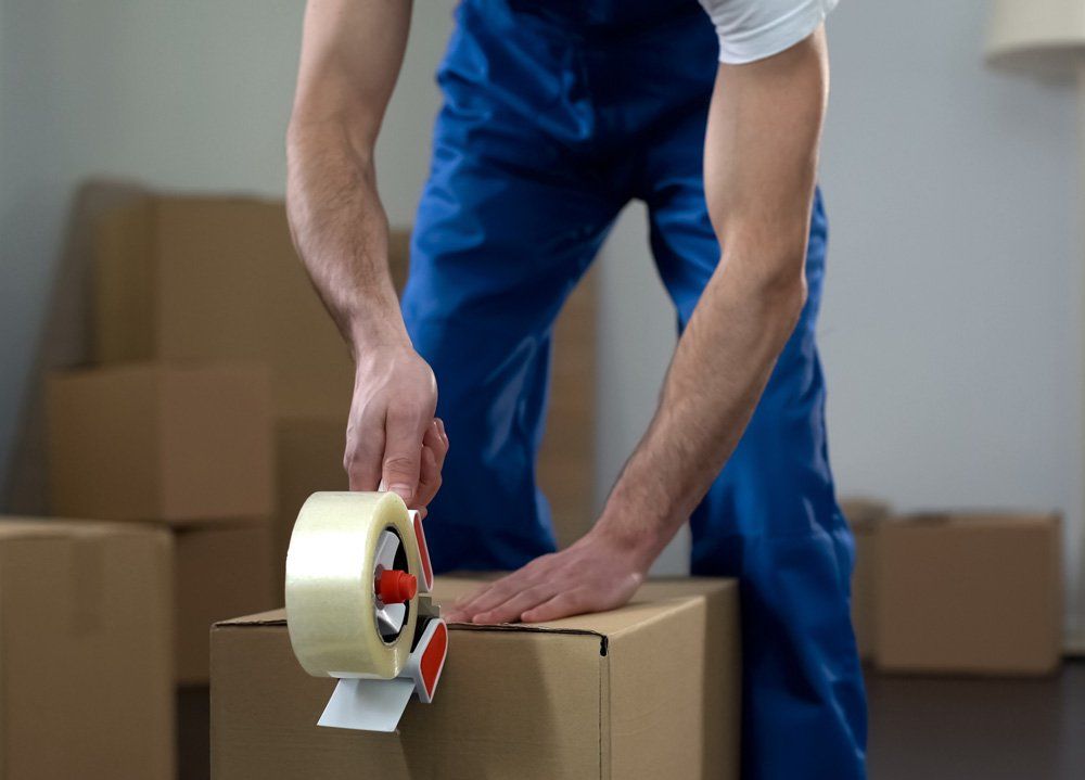 Worker Using Packaging Tape on Boxes — Geelong, VIC — Zippy Removals & Storage