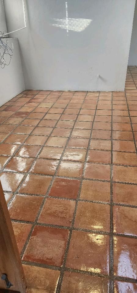A room with a tiled floor and a white wall.