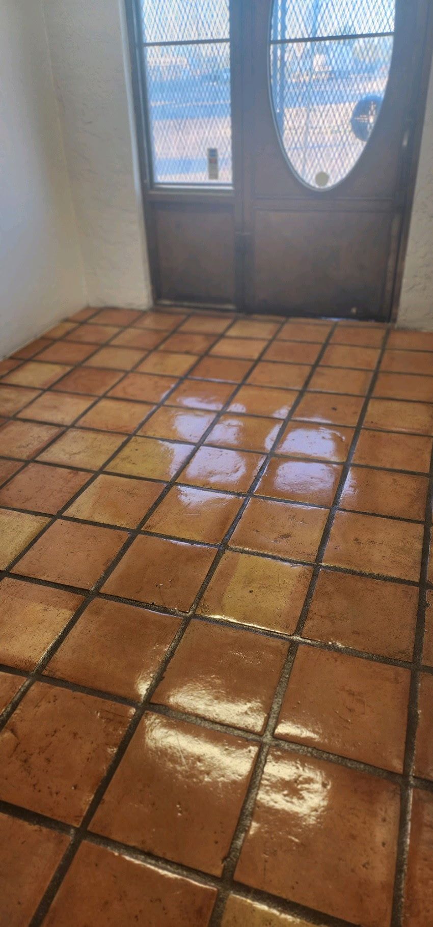 A room with a tiled floor and a door.