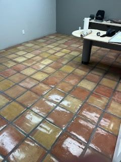 A room with a tiled floor and a desk.