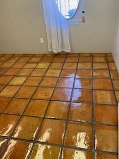 A room with a tiled floor and a window.
