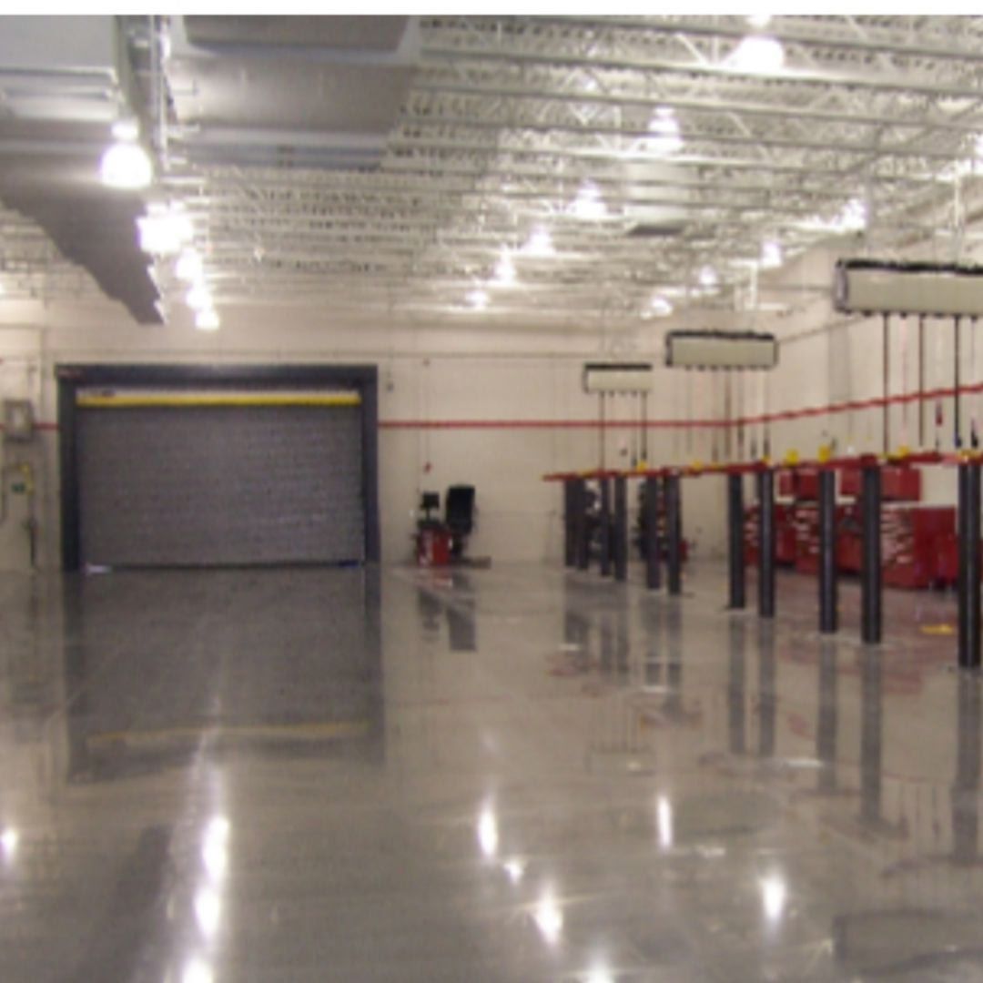 A large room with a garage door and tables