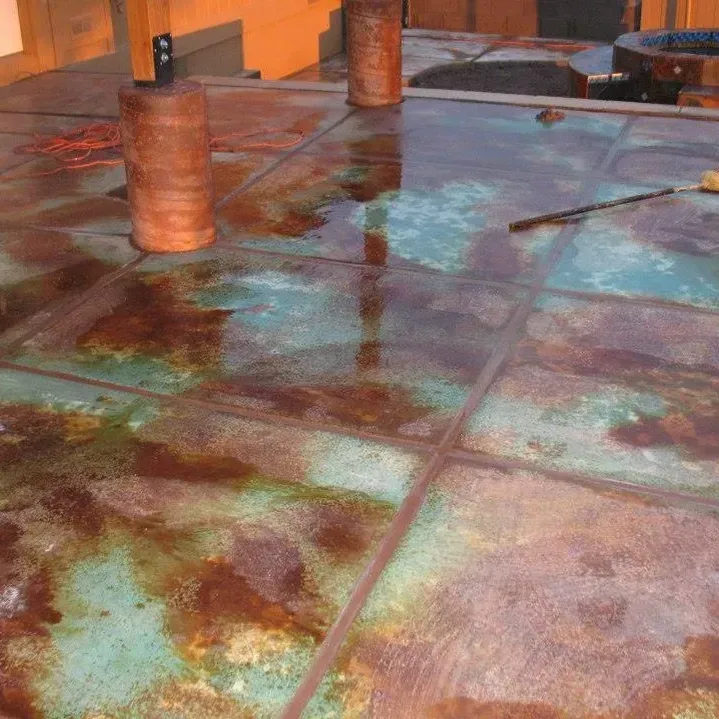 A close up of a concrete floor with a lot of stains on it.