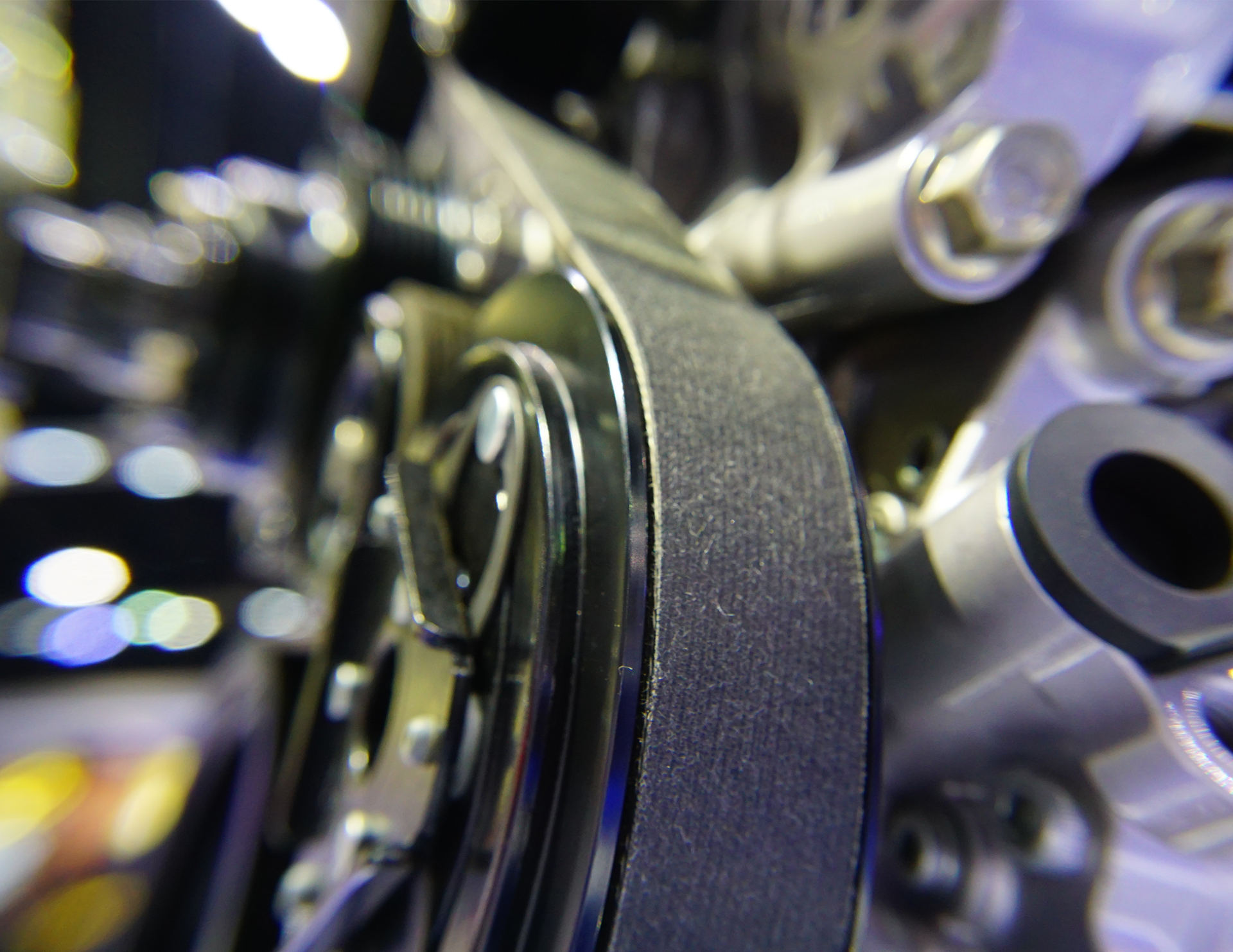 A man wearing gloves is working on a clutch disc