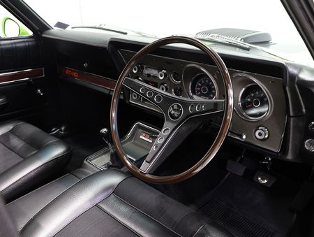 The interior of a car with a steering wheel and dashboard.