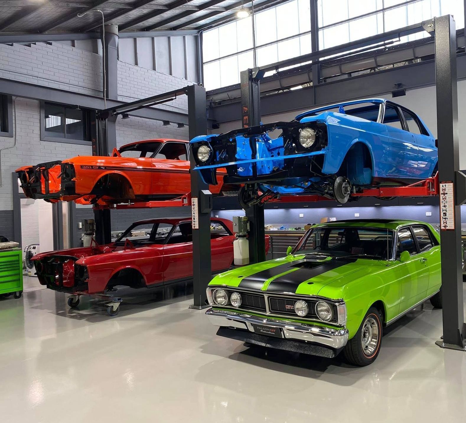 A Green Car Parked in a Show Room — About the Falcon GT & Our Services in Sydney, NSW